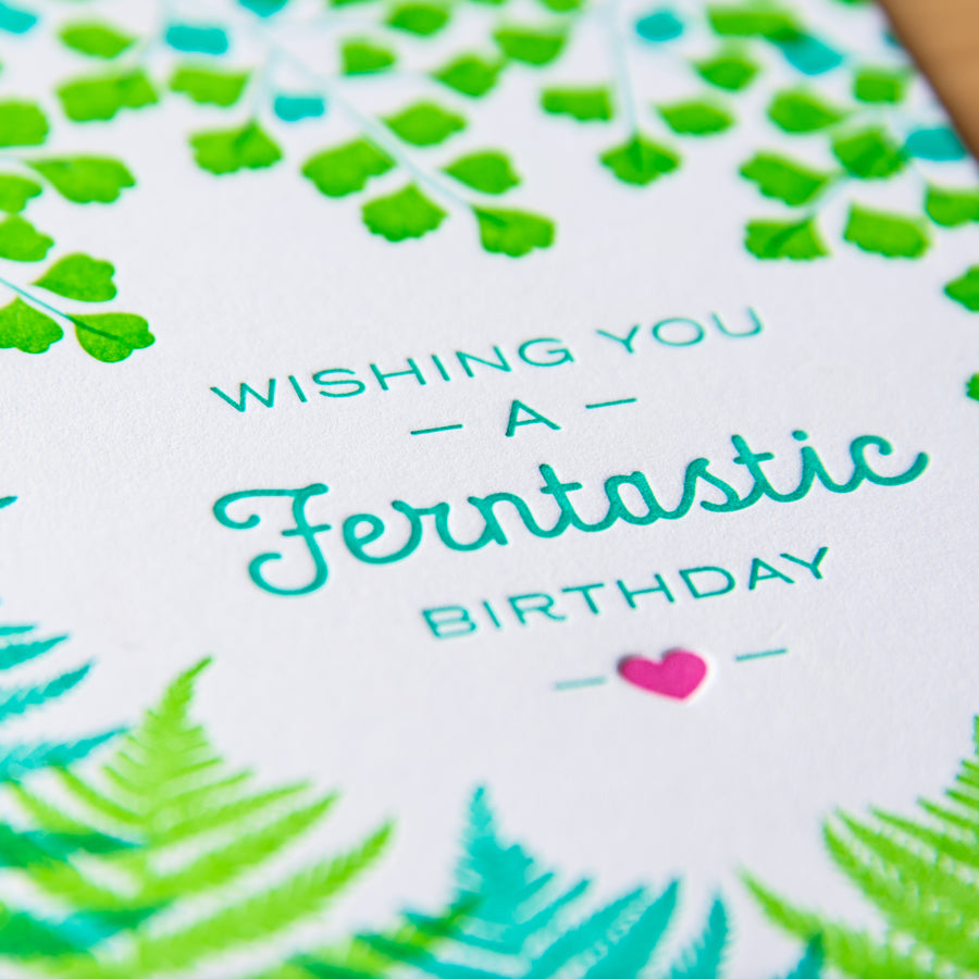 Letterpress greeting card with green ferns around the words Wishing You a Ferntastic Birthday
