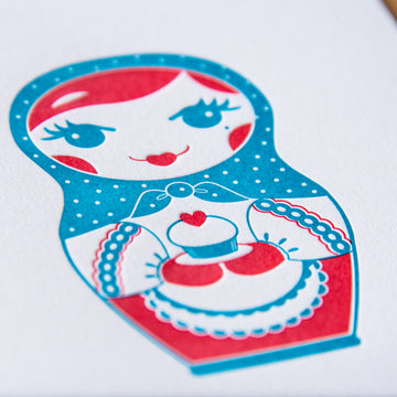 Letterpress birthday greeting card of nesting doll holding cupcake