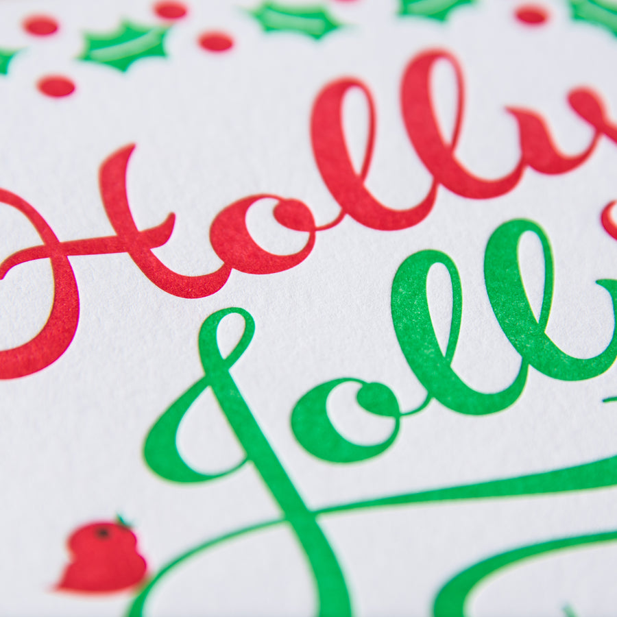 Letterpress holiday greeting card with the words Holly Jolly printed in green and red