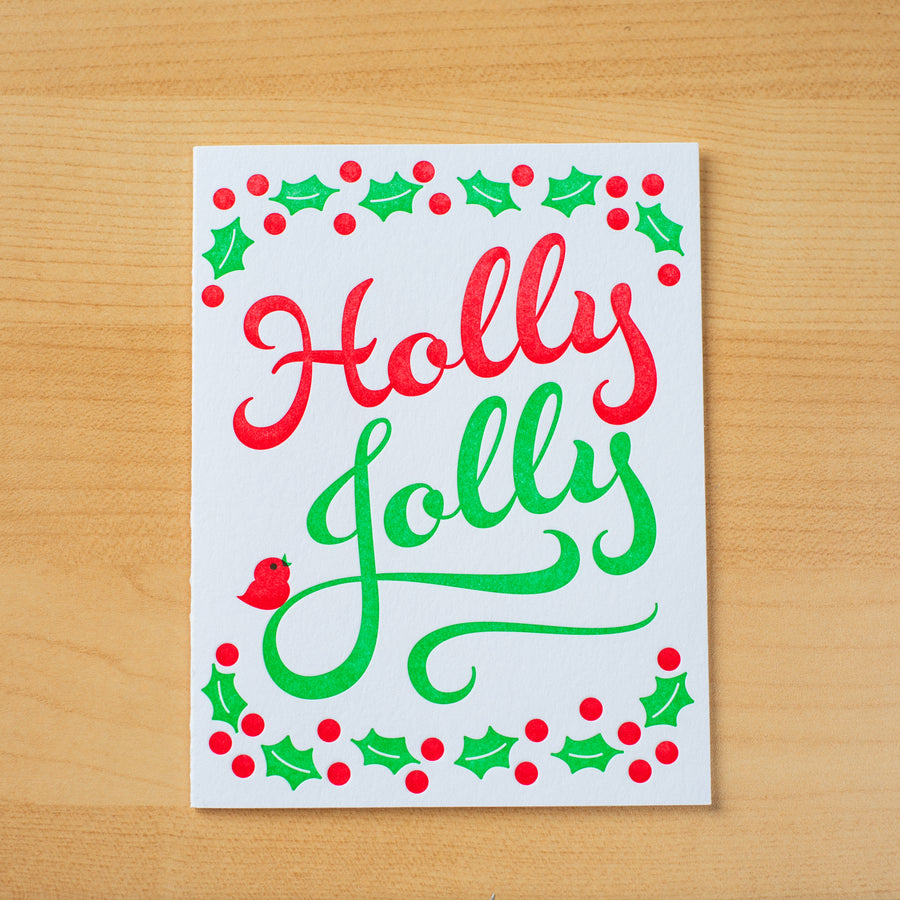 Letterpress holiday greeting card with the words Holly Jolly printed in green and red