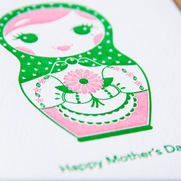 Letterpress Mother’s Day greeting card of a nesting doll holding a bouquet of flowers